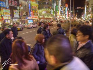 Getting lost in the nighttime atmosphere amidst the bright lights of the Shinjuku district in Tokyo, Japan.