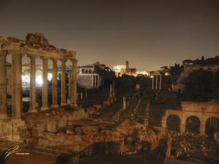 A long exposure photo of the ancient ruins of the Roman forum taken in the twilight hours in Rome, Italy.