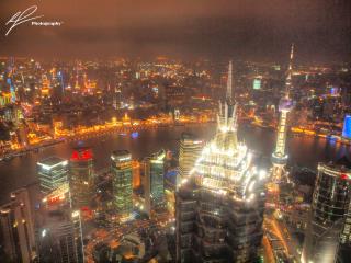 From the Jin Mao tower in the Pudong district in downtown Shanghai, we get a brilliant view of the city lights by night.